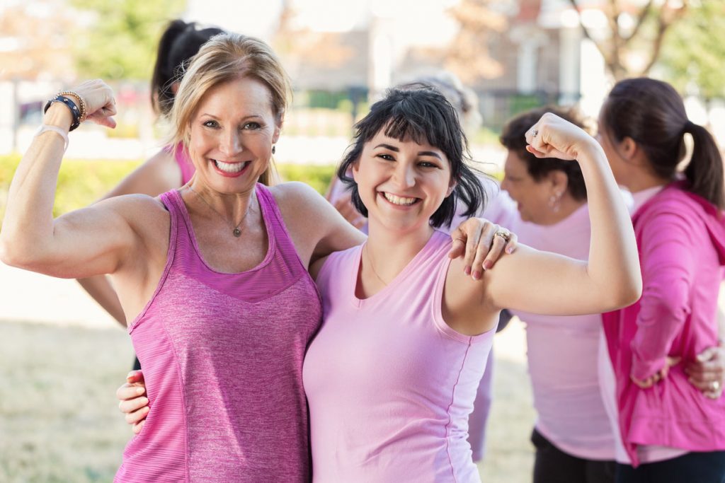 Women flexing their muscles at charity race